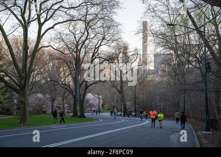 People running and walking at Central Park in New York City on a Spring day. Stock Photo