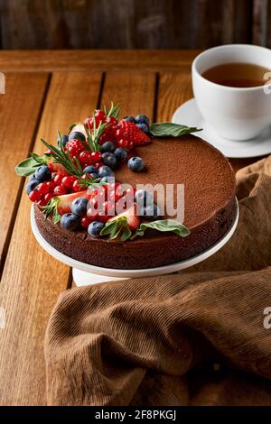 Chocolate cake from chocolate pancakes with icing, with blueberries. Copy space, selective focus Stock Photo