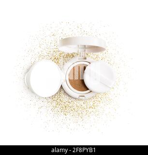 Foundation cushion powder with puff. Cosmetic face powder in the golden glitter circle isolated on white background. Stock Photo