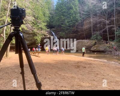 LOGAN, OHIO, UNITED STATES - Apr 09, 2021: waiting to photograph Lower falls while people enjoy the beautiful weather and scenic views in one of Ohio' Stock Photo