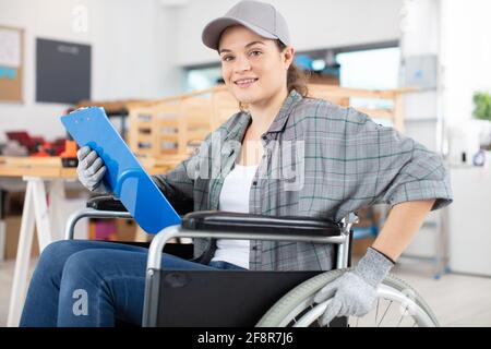 disable female carpenter using a saw Stock Photo