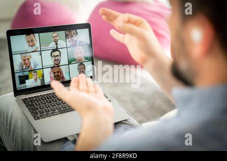 Mid adult man having online conference working at home Stock Photo