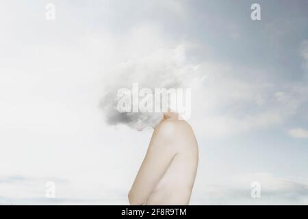 surreal image of a white cloud covering a woman's face, concept of freedom Stock Photo
