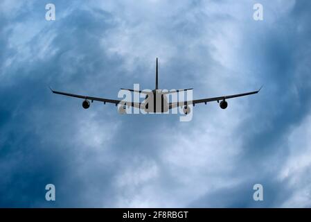 Airplane in Storm Clouds Stock Photo