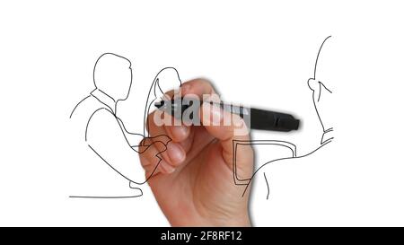 young man in glasses standing near whiteboard and pointing on the chart while his coworkers listening and sitting at the table Stock Photo