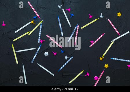 Striped candles on a dark background. Festive concept, birthday. Flat lay. Stock Photo