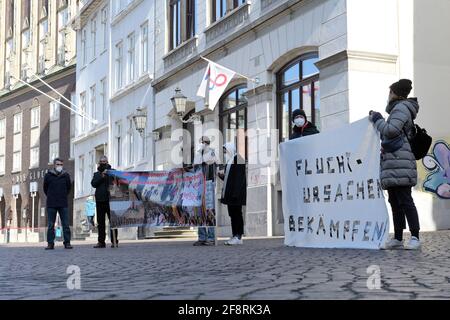 Bremen, Germany. 15th Apr, 2021. Demonstrators stand with banners in front of the Bremen concert hall 'Die Glocke' while the trial against the former head of the Bremen branch of the Federal Office for Migration and Refugees (BAMF) is being held in the building. Credit: Michael Bahlo/dpa/Alamy Live News Stock Photo