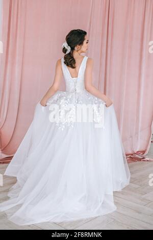 Portrait of a beautiful stylish bride with an elegant hairstyle view from the back. Stock Photo