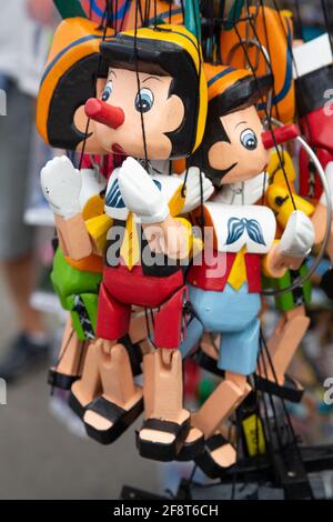 Souvenir Pinocchio puppets in a Street Market in Florence, italy Stock Photo