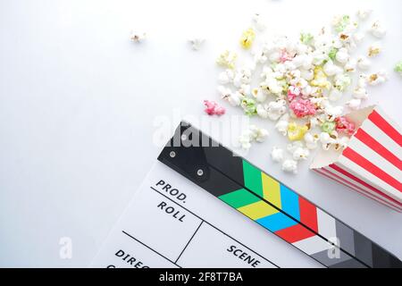 Movie clapper board and popcorn on white background  Stock Photo