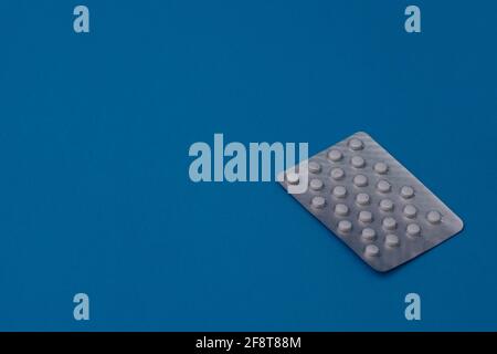 Tablets in a blister on a blue background. mock up Stock Photo