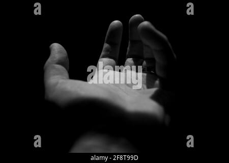 Reaching out hand in Black & White Stock Photo