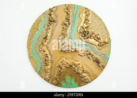 Round resin art painting with golden colors and glass. Stock Photo