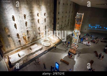 9/11 Memorial and Museum interior - looking down at The Last Column; Manhattan New York city USA.  People gathering around the Last Column at the 9/11 Stock Photo