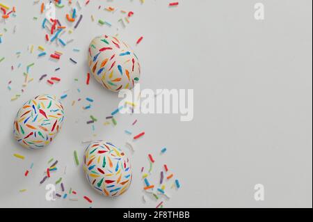 Painted Sprinkle Easter Eggs on white table Stock Photo