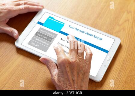 Mobile health concept: personal patient record on a tablet computer, hands of an old woman touching the screen. Stock Photo