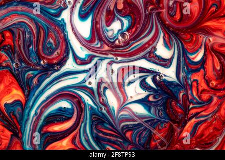 Fluid art, blue and red liquid paint, abstract modern background with bubbles, ink texture, surreal curve pattern, smeared wash drawing. Painted color Stock Photo