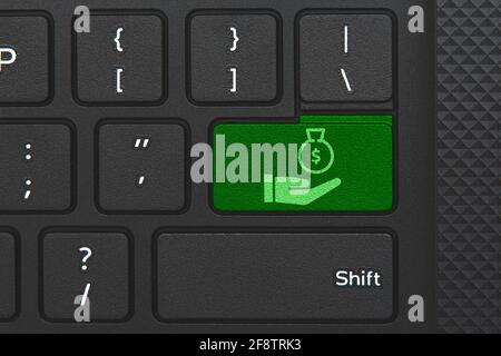 Money icon on computer keyboard. Conceptual idea of money, loan, mortage, earnings Stock Photo