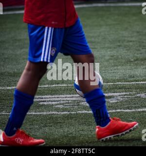 New Delhi, India - July 19 2019: Footballers of local football team during game in regional Derby championship on a bad football pitch. Hot moment of Stock Photo