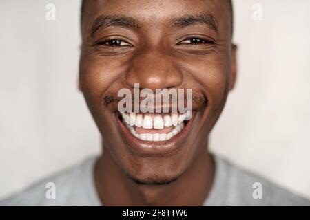 Closeup of a carefree young African man laughing Stock Photo
