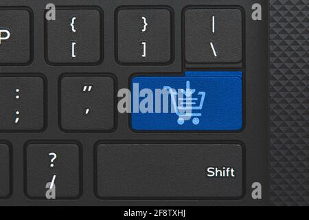 Shop cart icon on keyboard key. Conceptual idea of shopping online Stock Photo