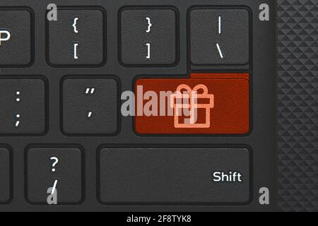 Present icon on PC keyboard key. Conceptual idea of present or surprise online Stock Photo