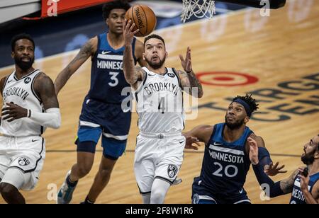 Minneapolis, United States. 13th Apr, 2021. Brooklyn Nets guard Chris Chiozza (4) scores over Minnesota Timberwolves forward Josh Okogie (20) at Target Center on Tuesday, April 13, 2021 in Minneapolis, Minnesota. (Photo by Jerry Holt/Minneapolis Star Tribune/TNS/Sipa USA) Credit: Sipa USA/Alamy Live News Stock Photo