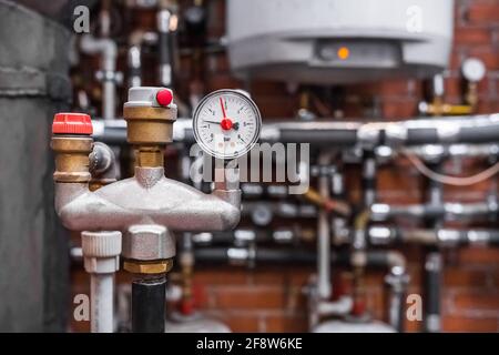 Industrial high-pressure piping system with safety valves and gauges.