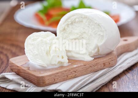 Buffalo Mozzarella, Italian cheese on wooden board. Stock Photo