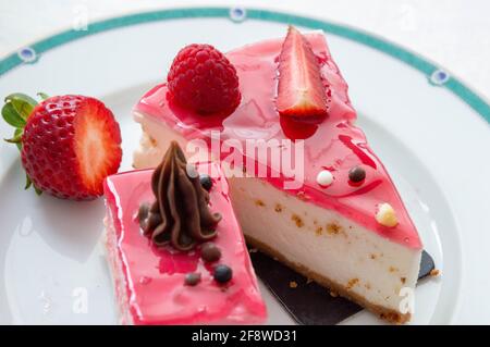 The cake on the plate is strawberry sponge cake and cottage cheese. Stock Photo