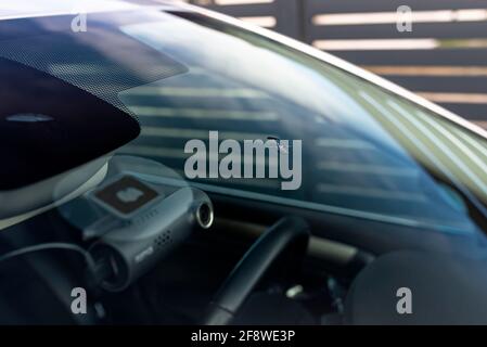 A hole in the center of the windshield made of stone from the wheels of the car in front. Stock Photo