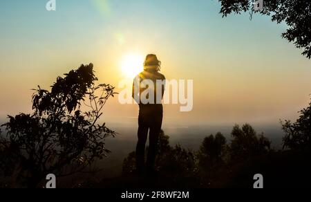 a man traveler standing in a top of a mountain in Bangladesh , Bandarban . Stock Photo