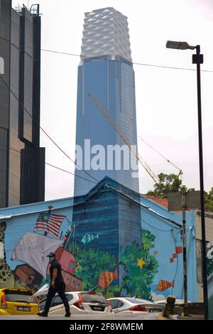 Kuala Lumpur, Malaysia. 15th Apr, 2021. A pedestrian walks near a mural seamlessly melted with the Exchange 106 tower in the background in Kuala Lumpur, Malaysia, April 15, 2021. Credit: Chong Voon Chung/Xinhua/Alamy Live News Stock Photo