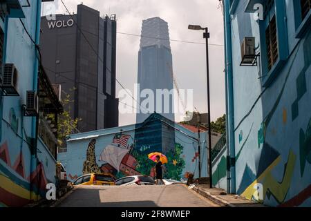 Kuala Lumpur, Malaysia. 15th Apr, 2021. A pedestrian walks near a mural seamlessly melted with the Exchange 106 tower in the background in Kuala Lumpur, Malaysia, April 15, 2021. Credit: Chong Voon Chung/Xinhua/Alamy Live News Stock Photo