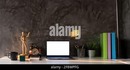 Laptop computer and office tools with blank screen on table with morning light. Stock Photo