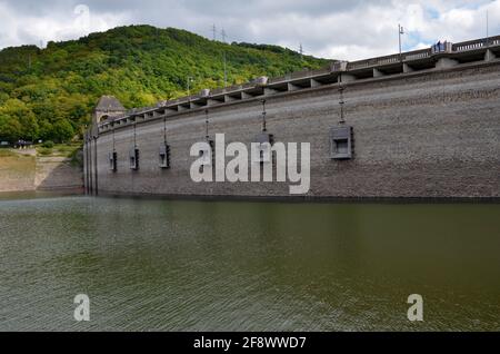 Dam at Edersee at low tide, with green mountains in the background Stock Photo