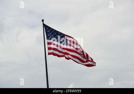 23. July 2013: New York, New York, USA: American flag blows in the wind in cloudy weather in New York Stock Photo