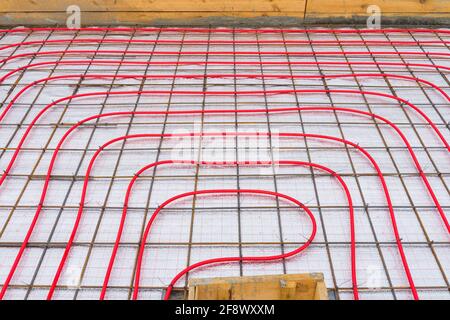 Underfloor plumbing pipes water heating installation before pouring the screed. Stock Photo