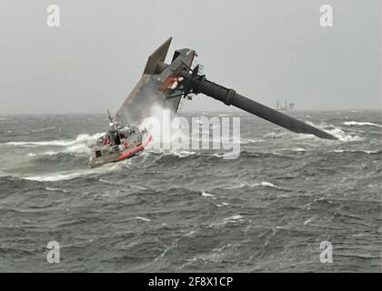 A 45-foot Medium Response Boat fights waves as it heads toward the capsized Seacor Power, 175-foot commercial lift boat capsized in the Gulf of Mexico April 13, 2021, 8 miles south of Grand Isle, Louisiana. The Coast Guard rescued six people from the oil service ship and 12 are still missing. Credit: Planetpix/Alamy Live News Stock Photo