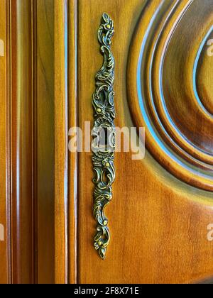 Refurbished antique wooden door with metallic keyhole. Concept and Idea for history, business, security background. Stock Photo