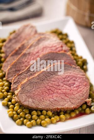 Roast Beef With Peas on a plate. High quality photo. Stock Photo