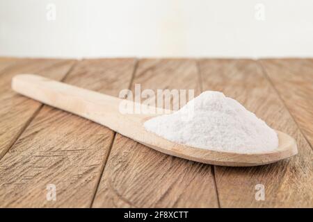 Baking soda (sodium bicarbonate) in a wooden spoon Stock Photo