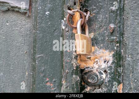 Padlock on black color wooden door closeup, closed secured house entrance. Traditional door detail, Plaka Athens Greece Stock Photo