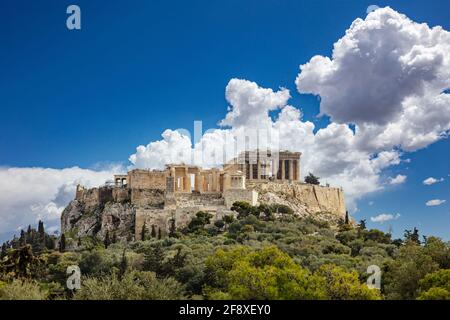 Athens, Greece. Acropolis and Parthenon temple, top landmark. Scenic view of ancient Greece remains from Philopappos Hill, blue cloudy sky background. Stock Photo