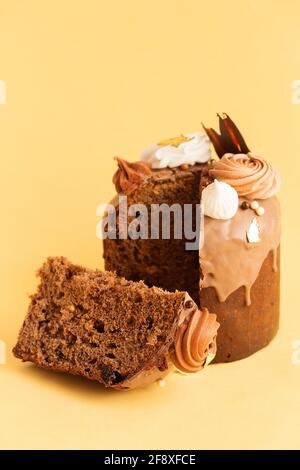 Easter Cake - Russian and Ukrainian Traditional Kulich decorated with sweets and marshmallows on yellow background. chocolate Easter Bread. Happy east Stock Photo