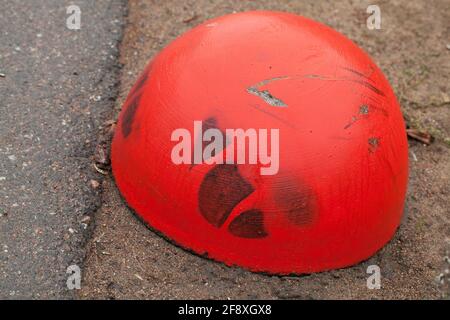 Red concrete anti-parking hemisphere-shaped bollard, close up photo Stock Photo