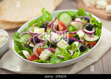 Greek salad with tomatoes, feta, olives and cucumbers. Stock Photo