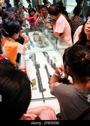 Crowds of tourists, visitors, people look at the many military guns, arms, rifles, landmines on display at the museum. At the Demilitarized Zone (DMZ) Stock Photo