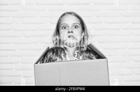 Make moving easier. Girl small child carry cardboard box. Move out concept. Prepare for moving. Rent house. Real estate. Delivering your purchase. Kid Stock Photo