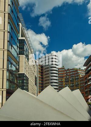 Paddington UK Aug 2018 - A renewed city skyline of modern glass and steel residential and office buildings with a bright blue sky with fluffy clouds. Stock Photo